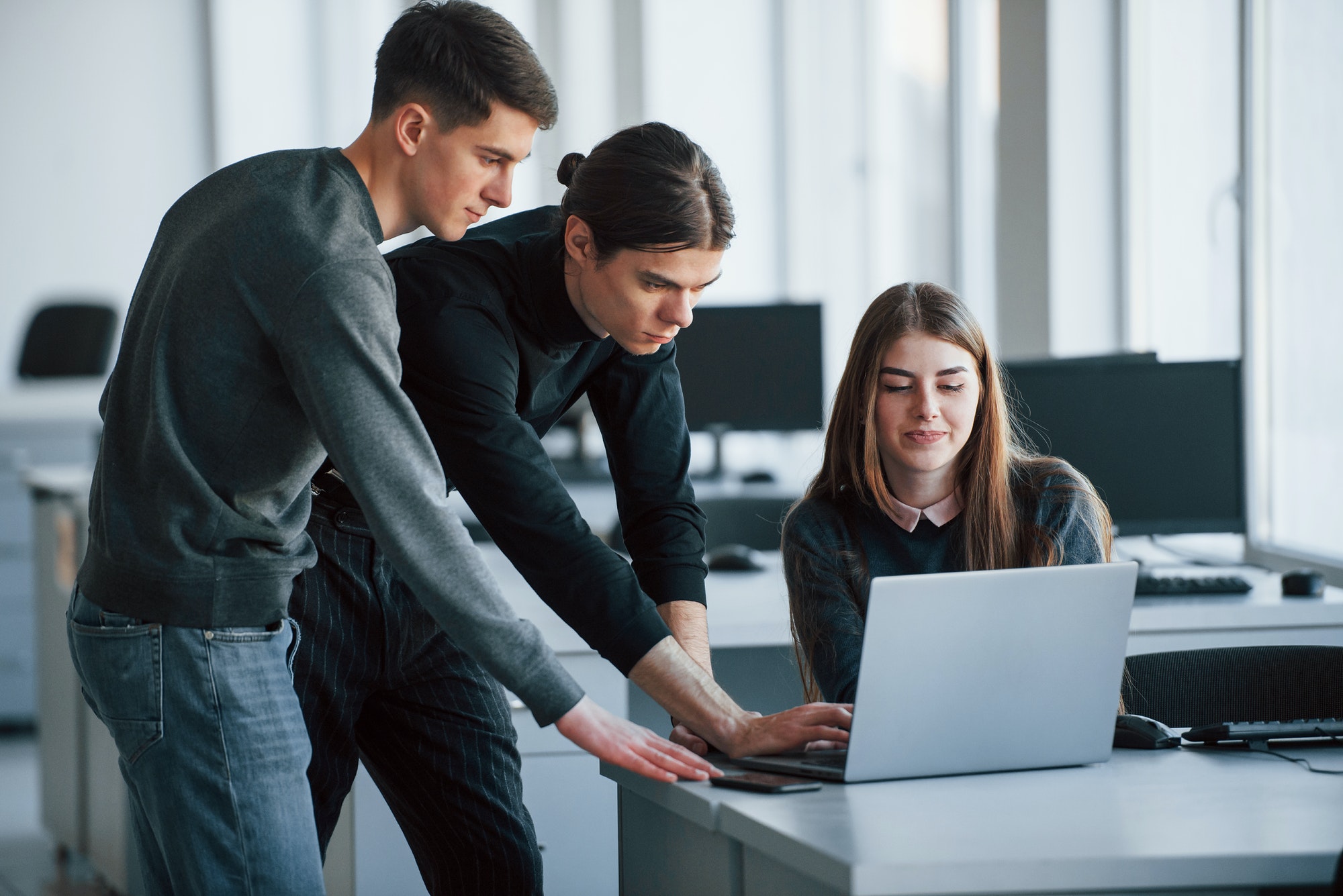 Results will be worth it. Group of young people in casual clothes working in the modern office